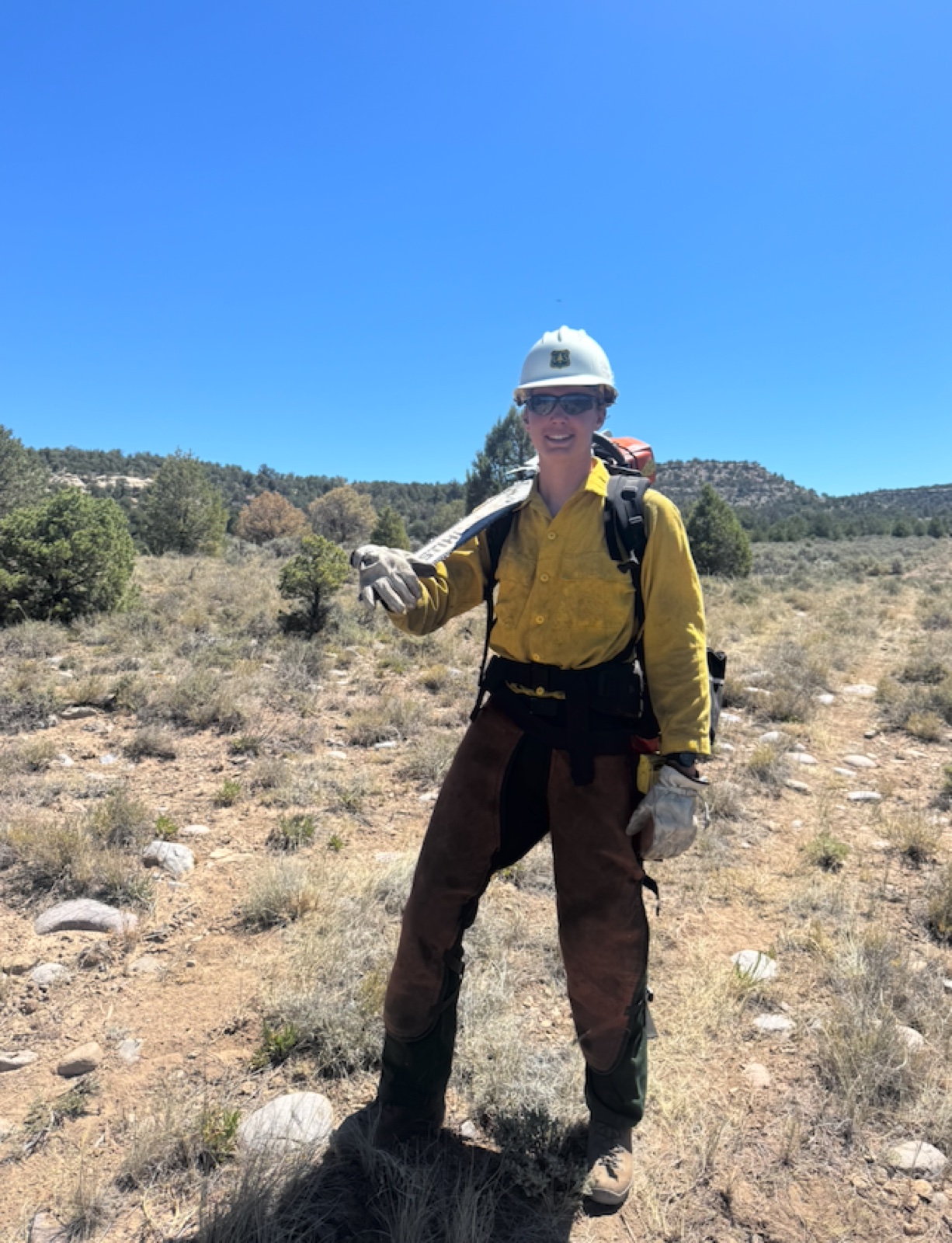 Graham in fire clothes holding a hand tool